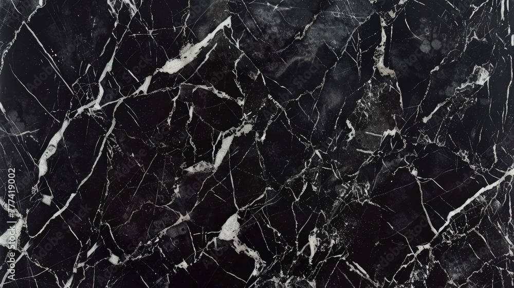 A close-up of natural black marble, emphasizing its rich textures and intricate veining in shades of grey and white, ideal for a detailed and realistic wallpaper or tile design.