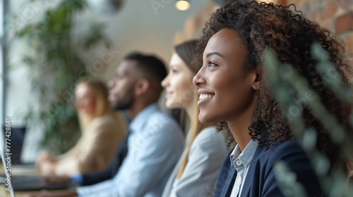 A group of diverse colleagues engaged in a productive team meeting, showcasing teamwork in a modern office setting.