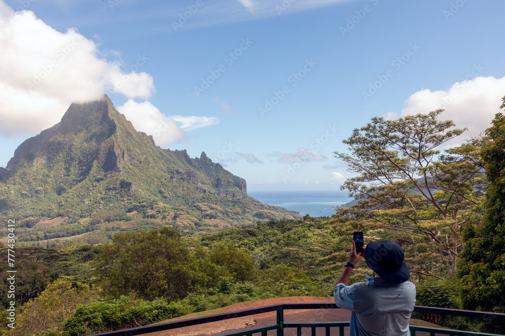 Naklejka premium Part of the lush South Pacific island of Mo'orea, French Polynesia, is seen from the lagoon that surrounds the island.