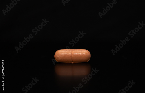close up of an isolated pill on black background