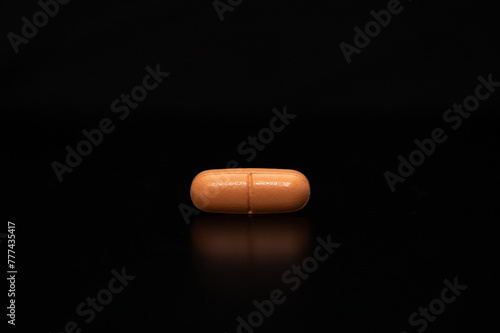 close up with a pill on a black background