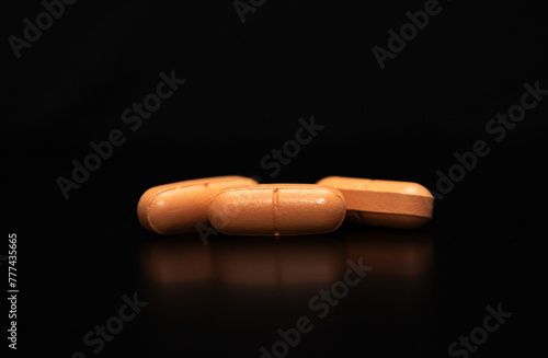close up with some pills on a black background