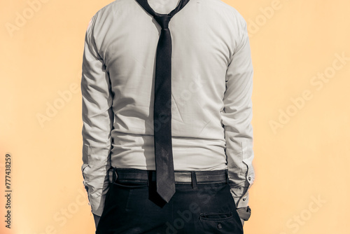 businessman in white shirt with black pent on peach color background photo