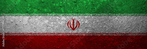 Banner of the grunge Iran flag. Dirty Iranian flag on a metal surface. © andyborodaty