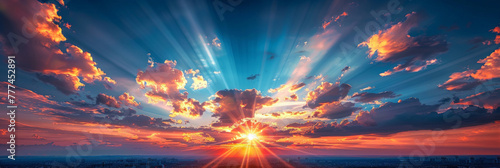 A beautiful sunrise with the sun shining through the clouds,  rays of golden light across the blue  sky. sunrise or sunset nature background. banner