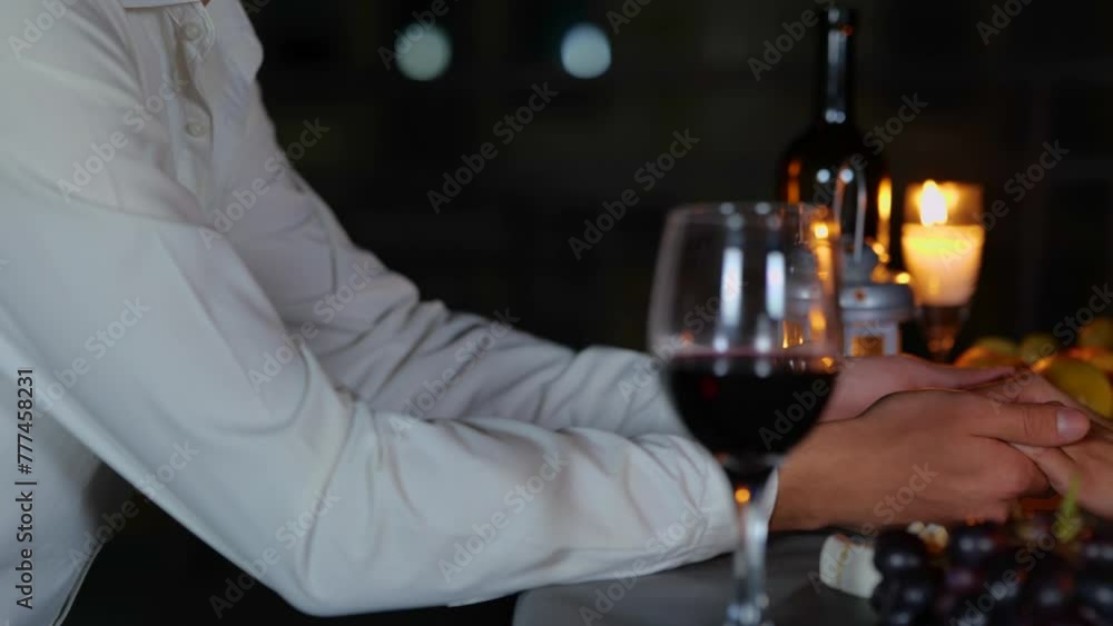 Lovers holding hands on a date at night Lovers holding hands on a date at night