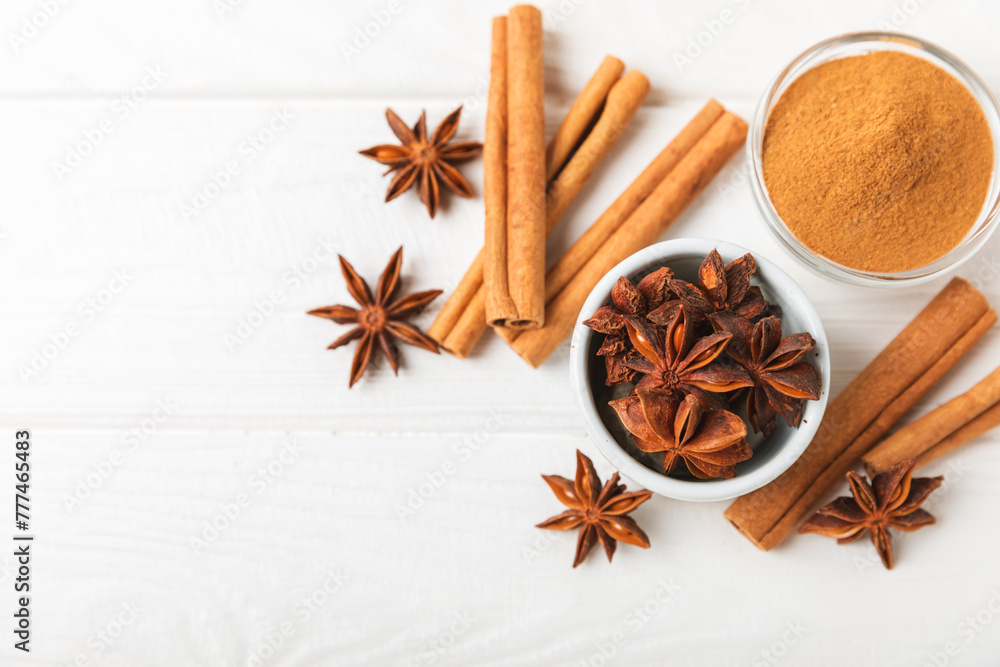 Ceylon cinnamon sticks and anise on a textured wooden background.Cinnamon roll and star anise. Spicy spice for baking, desserts and drinks. Fragrant ground cinnamon.Place for text. copy space. Ceylon cinnamon sticks and anise on a textured wooden background.Cinnamon roll and star anise. Spicy spice for baking, desserts and drinks. Fragrant ground cinnamon.Place for text. copy space.
