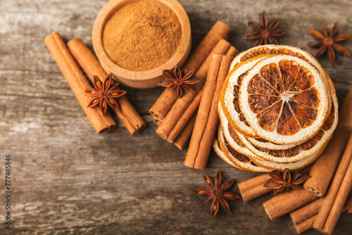 Ceylon cinnamon sticks and anise on a textured wooden background.Cinnamon roll and star anise. Spicy spice for baking, desserts and drinks. Fragrant ground cinnamon.Place for text. copy space.