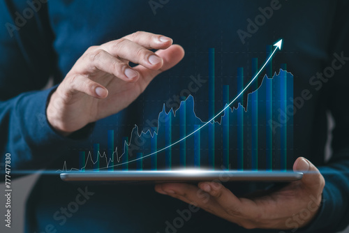 BusinessMan hand using tablet checking stock market graph report via mobile app. finance and investment, trading, currency exchange, economic growth, stock market analysis concept.