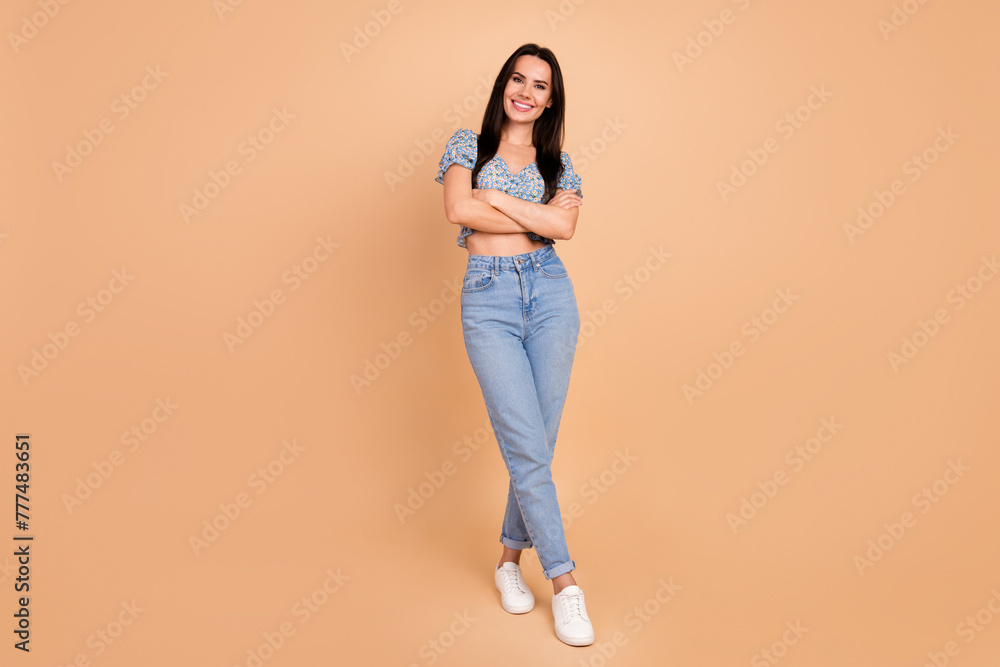 Photo of cute lovely stunning woman wear blue stylish outfit clothes crossed arms isolated on beige color background Photo of cute lovely stunning woman wear blue stylish outfit clothes crossed arms isolated on beige color background