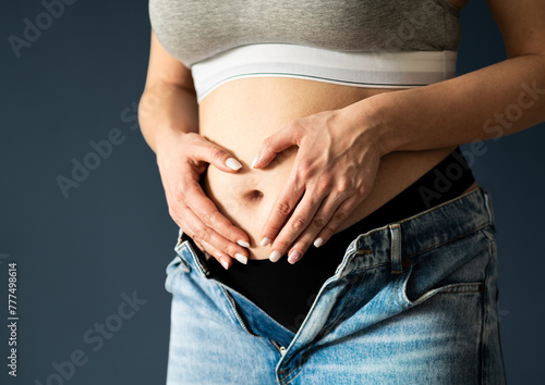 Stomach of pregnant woman, first or second trimester. Early pregnancy. Healthy belly or tummy ache. Heart with hands. Menstrual pain, gynecology. Bacteria, infection, diarrhea or inflammation care.
