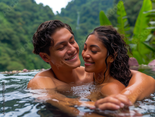 Intimate moment of a couple relaxing together in a tropical hot spring, surrounded by nature.