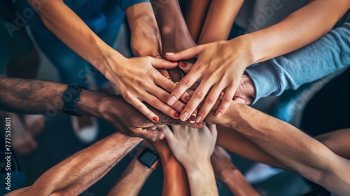 Top-down view of diverse hands together in a symbol of unity