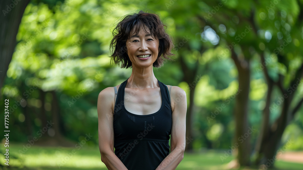 Beautiful athletic Asian woman in black sportswear doing sports in the park. Beautiful athletic Asian woman in black sportswear doing sports in the park.