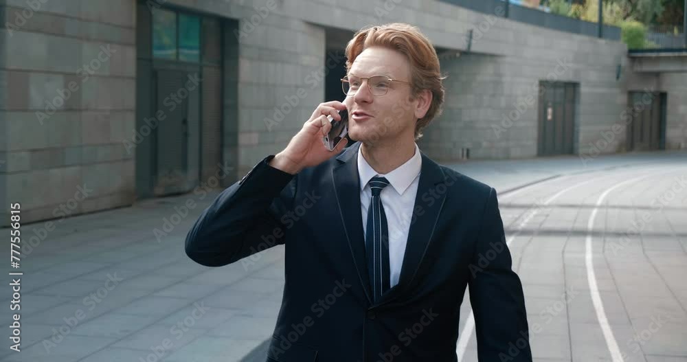Businessman strides confidently down street discussing work matters on phone Focus on work is clear. Phone conversation crucial part of his work showcases his dedication to his projects. Businessman strides confidently down street discussing work matters on phone Focus on work is clear. Phone conversation crucial part of his work showcases his dedication to his projects.