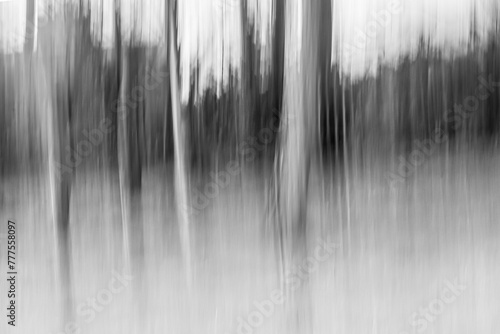 London, UK, 3 March 2024: Intentional camera movement ICM photo of a  forest on a sunny summer day. Blurred nature background concept 