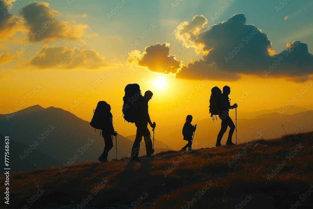 Obraz premium Adventure Seekers: Family Silhouette against Majestic Mountains