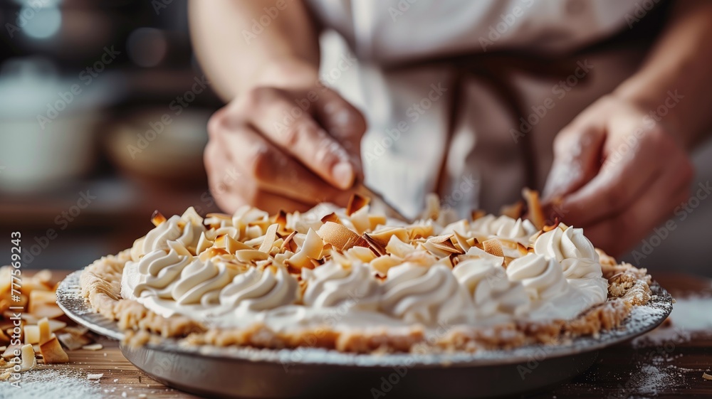 Person is garnishing whipped cream-topped pie with fruit pieces in kitchen