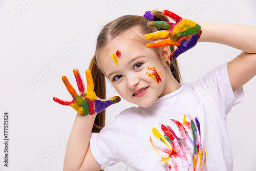 Happy little cute girl showing painted palm, hands on white background. Children creativity concept. advertising of children's products and educational clubs