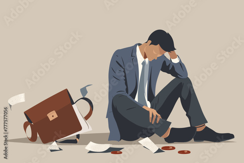 Dejected businessman sits on the ground with an empty wallet, facing financial loss, bankruptcy, and ruin, a concept of business failure and hardship photo