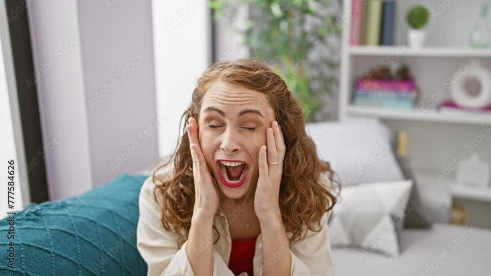 Cheerful young woman, radiating confidence, caught by a surprise while comfortably sitting on a cozy sofa at home Cheerful young woman, radiating confidence, caught by a surprise while comfortably sitting on a cozy sofa at home