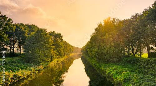 Sunset lighting slightly foggy canal  Wilhelminakanaal  near the village of Aarle-Rixtel  The Netherlands.