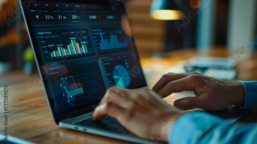 A person is typing on a laptop with a stock market graph on the screen. The person is focused on the screen and he is working on something related to finance or trading. photo