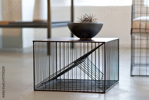 A minimalist wireframe side table with angular lines and negative space, embodying the principles of modernist design in a sleek urban interior.
