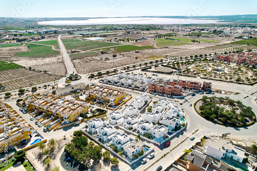 Aerial image panoramic photo Los Montesinos townscape with luxury villas, agricultural fields, salt lakes and countryside located in the province of Alicante, Valencian Community, Spain © Alex Tihonov