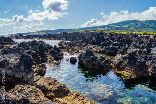 Transparent natural sea pools in Biscoitos with mountain in the background, Terceira - Azores PORTUGAL