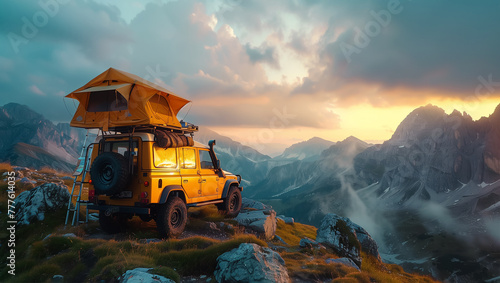 A yellow off-road vehicle with rooftop tent parked on cliff overlooking majestic mountain scenery at sunset. Adventure camping in wilderness with breathtaking views of rugged peaks and dramatic clouds © Soloviova Liudmyla