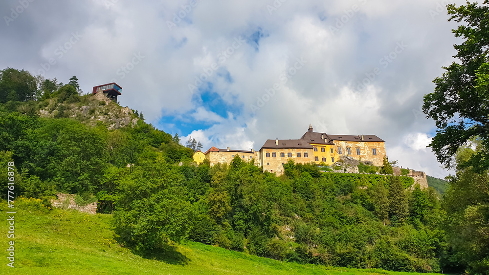 Panoramic view of medieval castle Rabenstein on a hill in Frohnleiten, Murtal, Styria (Steiermark), Austria. Travel destination sunny day in summer. Surrounded by idyllic forest in foothills of Alps