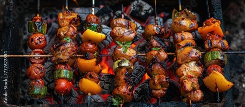 A variety of grilled kebabs loaded with vegetables cooking on a grill, releasing delicious aromas as they sizzle over the flames.