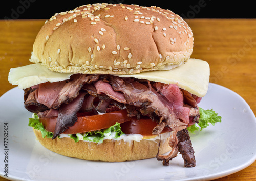 roast beef sandwich with  tomatoes and cheese photo