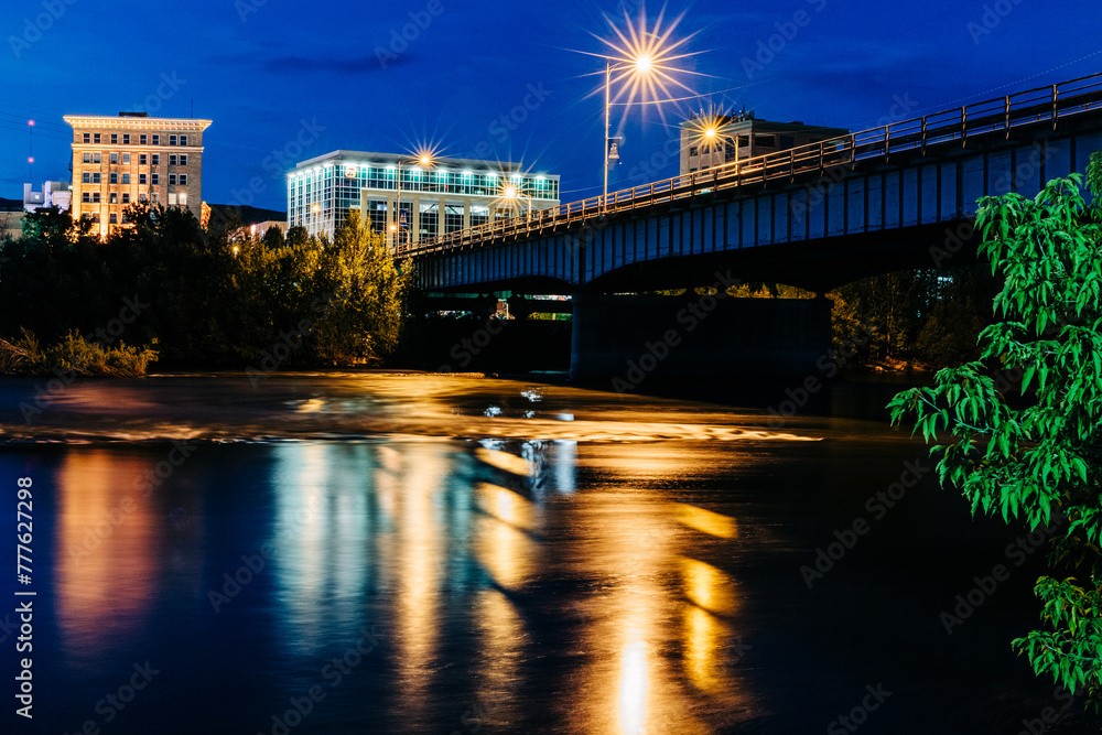 Downtown Missoula and Clark Fork River at night with sunburst