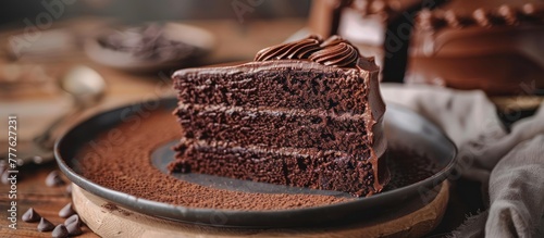 A rich slice of chocolate cake sits temptingly on a white plate, ready to be enjoyed. photo