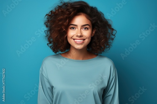 Portrait of attractive girl isolated on blue background. © Bargais