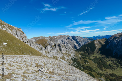 Panoramic view of majestic mountain peak Ringkamp in untamed Hochschwab mountain region, Styria, Austria. Scenic hiking trail on blue sky sunny day in remote Austrian Alps. Wanderlust in alpine spring photo