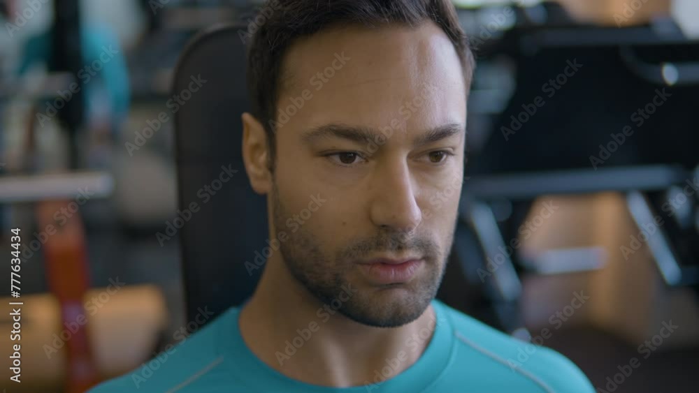Portrait of Man While Doing Sitted Dumbbell Bicep Curls in Gym Portrait of Man While Doing Sitted Dumbbell Bicep Curls in Gym