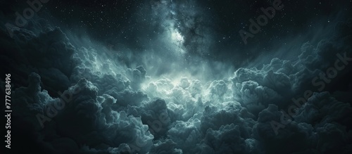 A night sky covered in thick clouds with stars twinkling through them. © FryArt Studio