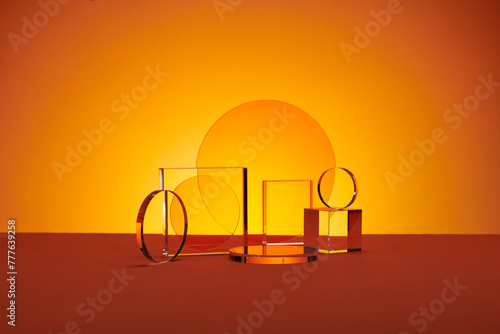 Acrylic empty podium for product presentation on orange background photo