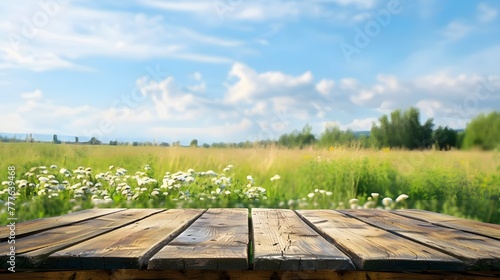 Clean wooden background. Against the background of green grass and clouds.