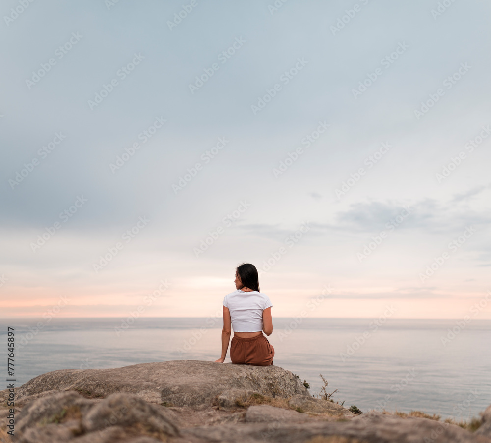Enjoying relaxing sea view sitting on top of cliff Enjoying relaxing sea view sitting on top of cliff