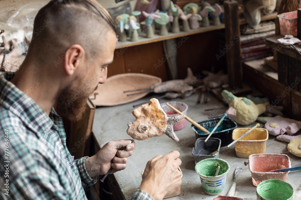 © Demetr White/Stocksy - painting the sculpture