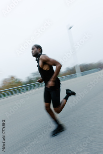 A black athlete trains his endurance running in the streets photo