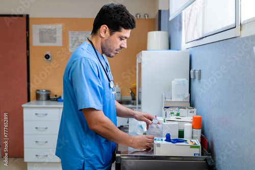 male doctor using medication dispenser photo