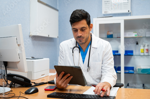 doctor using a tablet computer in a medical office photo