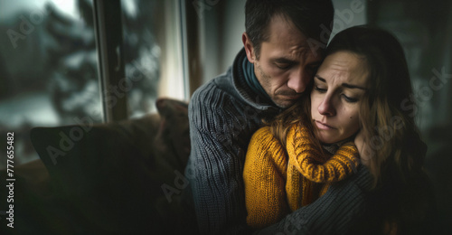 Banner of worried male embracing to desperate female at home photo