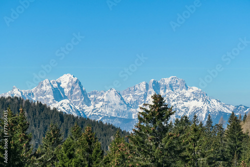 Scenic view of snowcapped mountain peaks of Julian Alps seen from Dreilaendereck, Karawanks, Carinthia, Austria. Hiking in remote alpine landscape in early springtime in Austrian Alps. Wanderlust