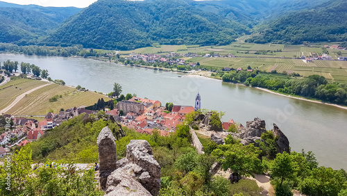 Panoramic aerial view of idyllic town of Duernstein in Krems an der Donau, Lower Austria, Europe. Awarded wine region of Wachau along the Danube river. Red roofs of houses of town center photo